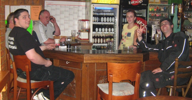 4 men ad a young bar gilr in a bar at lebach